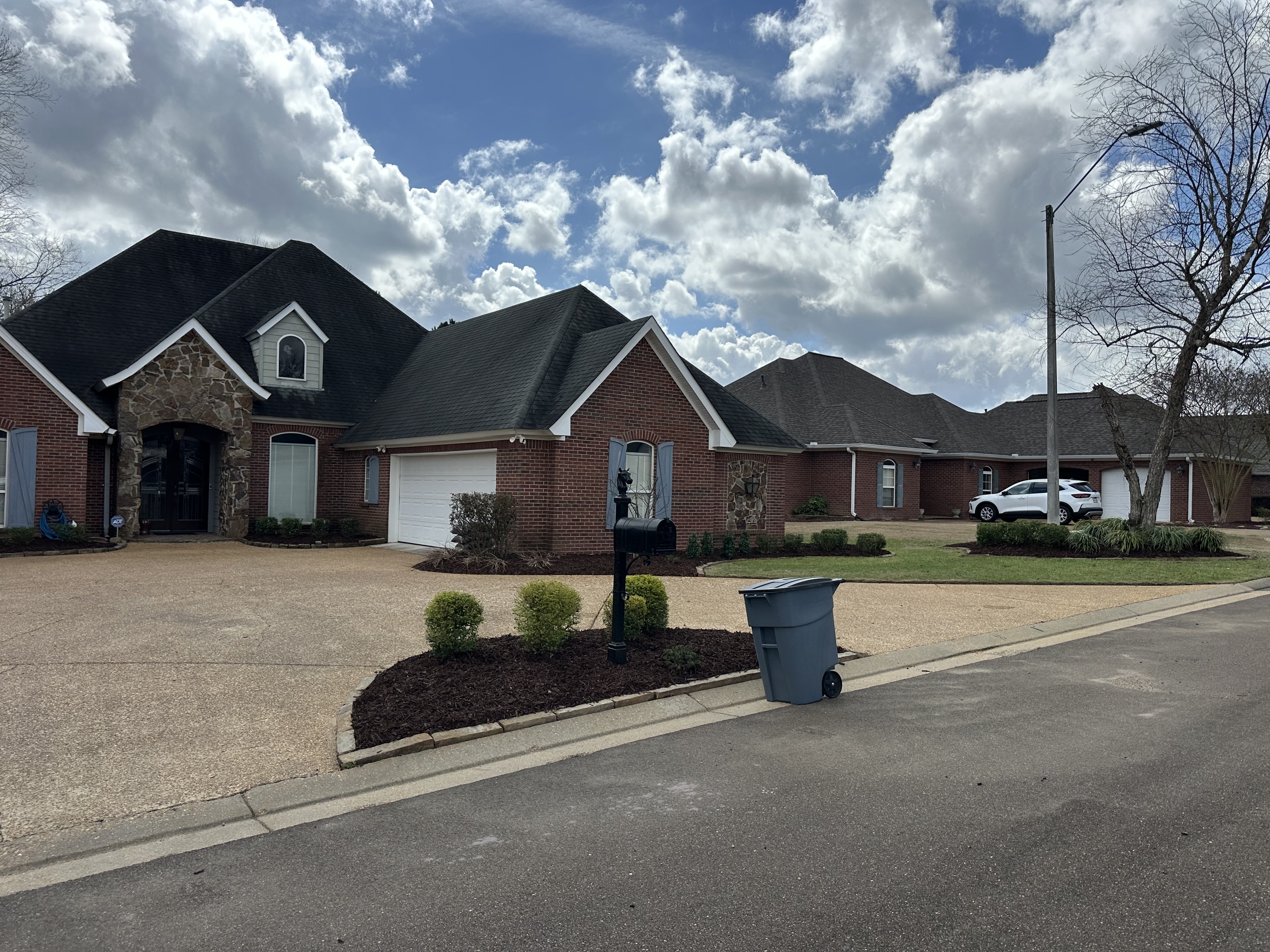Fresh mulch beds at brick home